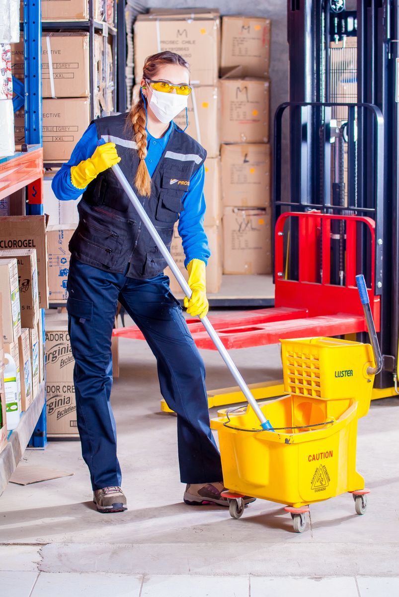 Commercial cleaner mopping the floor of a large facility